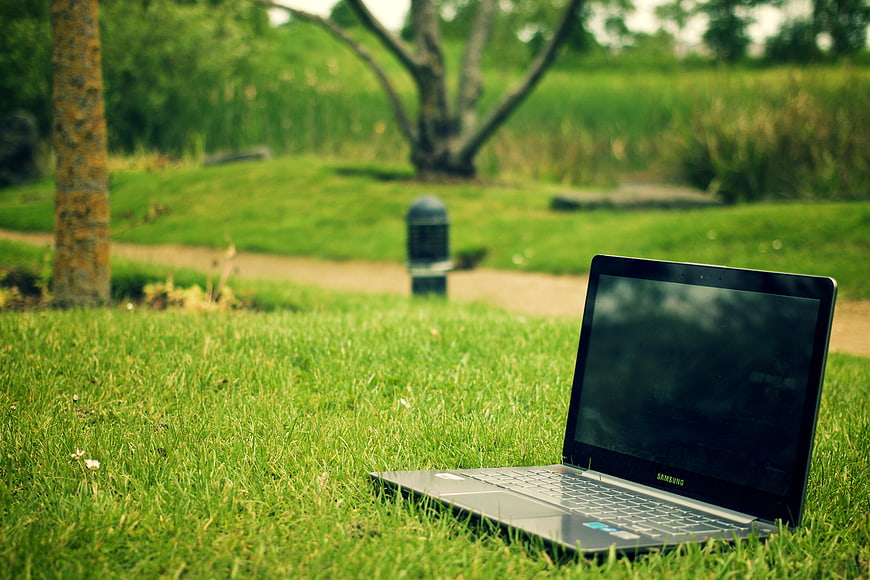Open Laptop on Green Grass in Park