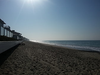 Sandy Beach with Modern Houses and Blue Ocean