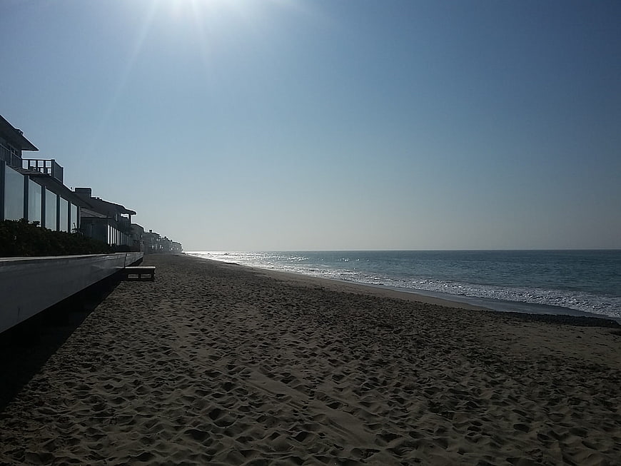 Sandy Beach with Modern Houses and Blue Ocean