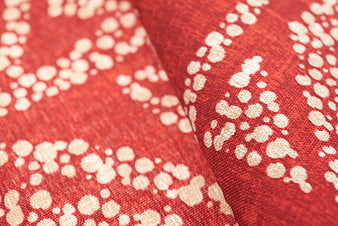 Close-up of red fabric with white dotted pattern texture