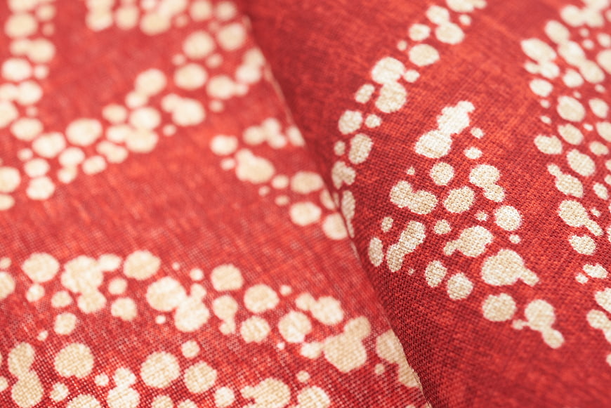 Close-up of red fabric with white dotted pattern texture