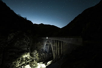 Night Sky Over Stone Arch Bridge in Mountain Canyon