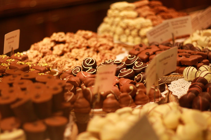 Assorted traditional chocolates and pralines in a bakery display case