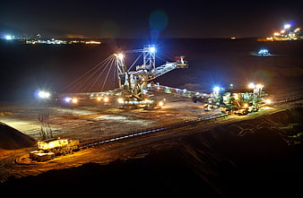 Nighttime Open Pit Coal Mining Operation With Heavy Machinery
