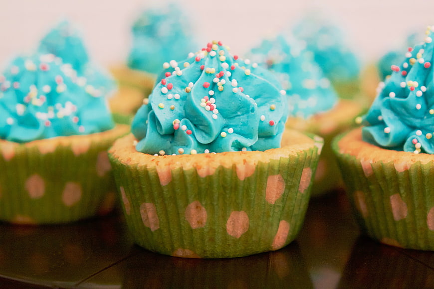 Blue Frosted Cupcakes with Sprinkles in Green Polka Dot Liners