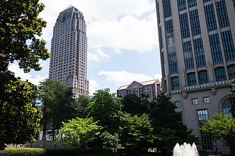 Urban Skyscrapers and Green Park with Fountain