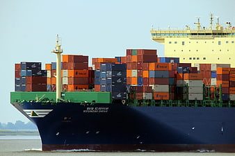 Large container ship named Hyundai Drive loaded with colorful cargo containers
