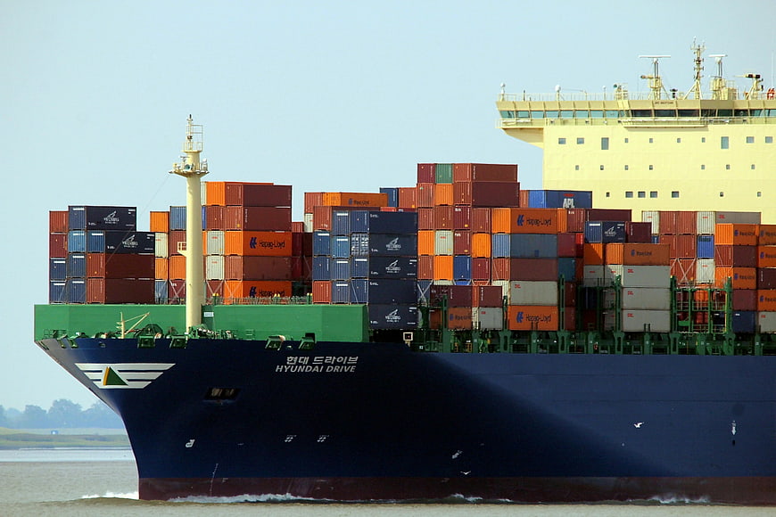 Large container ship named Hyundai Drive loaded with colorful cargo containers
