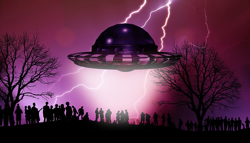 Silhouette of crowd watching UFO with lightning