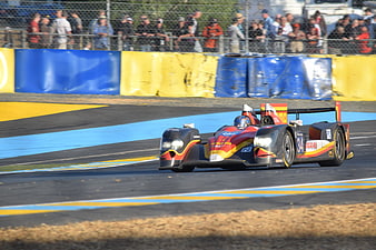 Red and Yellow Race Car Speeding on Track