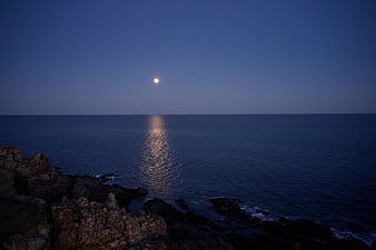 Moonlight Reflection on Calm Ocean at Dusk