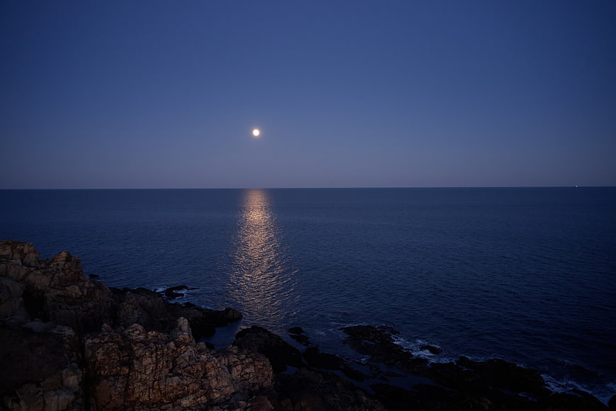 Moonlight Reflection on Calm Ocean at Dusk