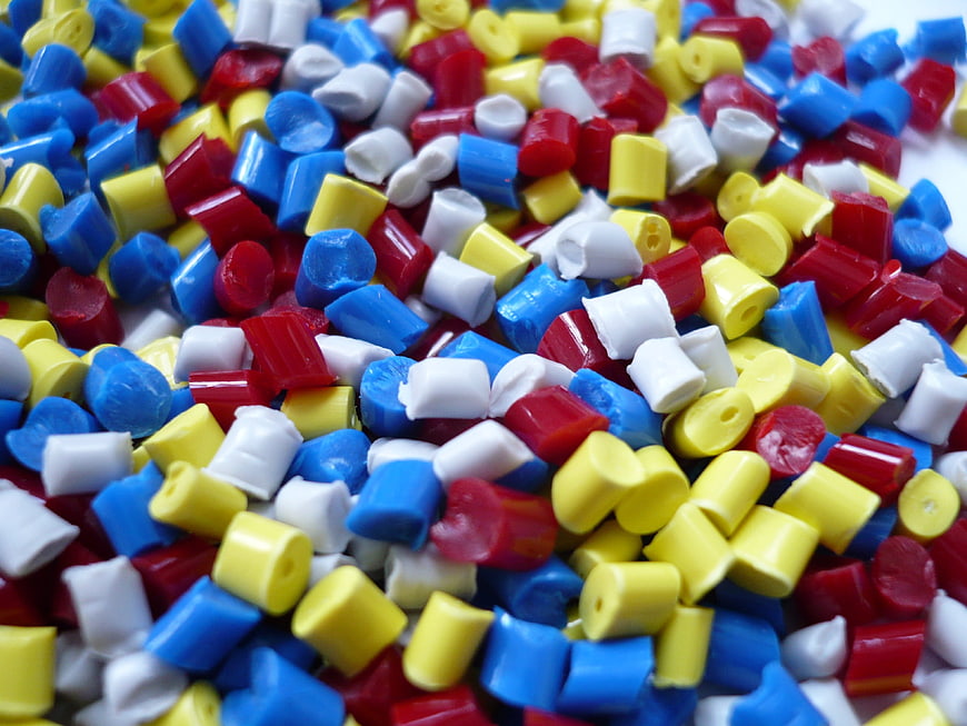 Colorful plastic polymer granules close-up texture