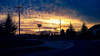 Dramatic Sunset Sky Over Suburban Street Intersection