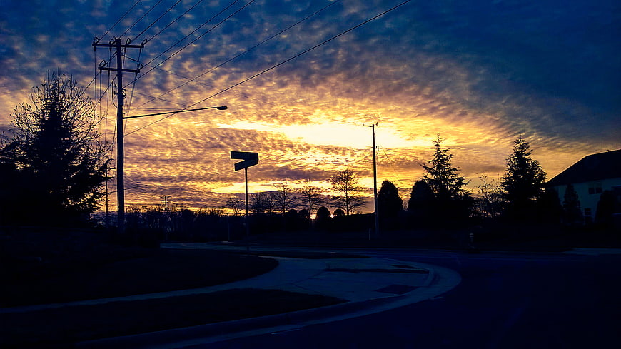 Dramatic Sunset Sky Over Suburban Street Intersection