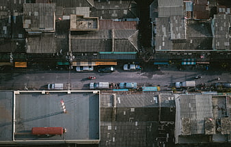 Aerial view of urban street with cars and rooftops