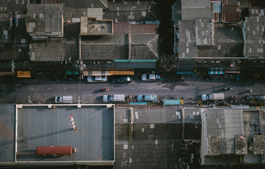 Aerial view of urban street with cars and rooftops
