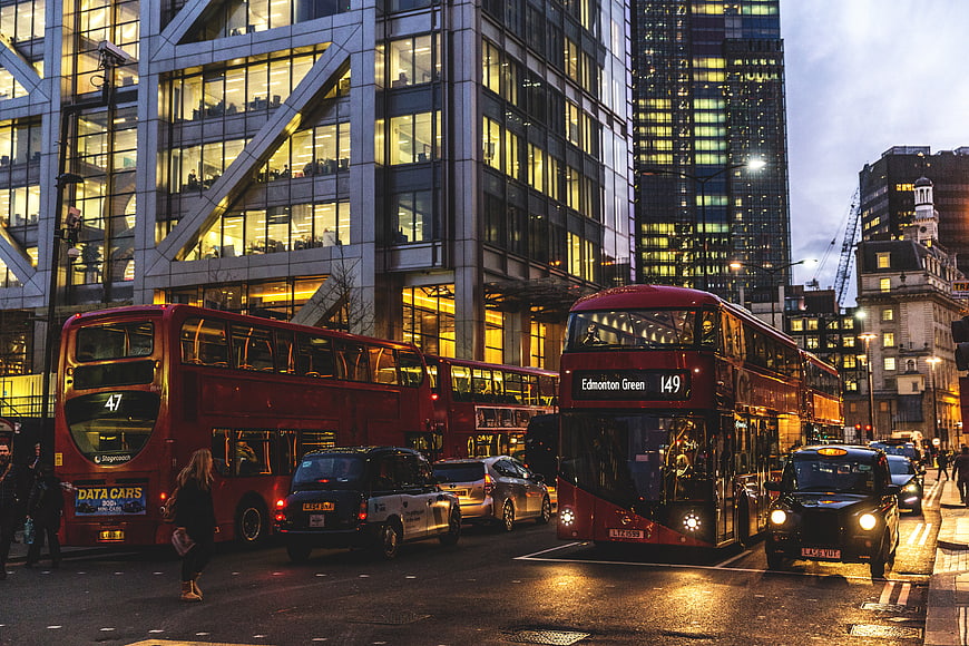 London City Traffic with Red Double-Decker Buses and Black Cabs
