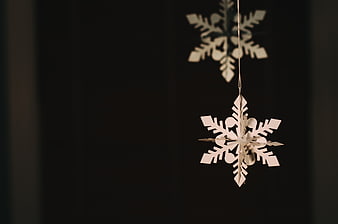 Hanging Wooden Snowflake Ornaments on Dark Background