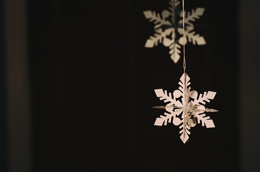 Hanging Wooden Snowflake Ornaments on Dark Background