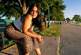 Woman in Leopard Print Skirt Sitting on Park Bench