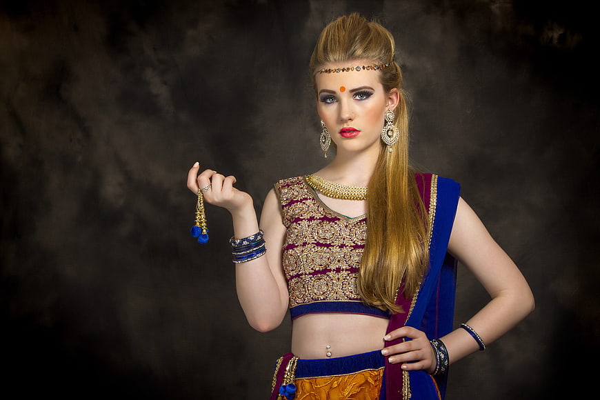 Blonde woman in traditional Indian bridal attire and jewelry