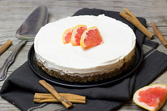 No-Bake Cheesecake With Grapefruit And Cinnamon Sticks On Rustic Table
