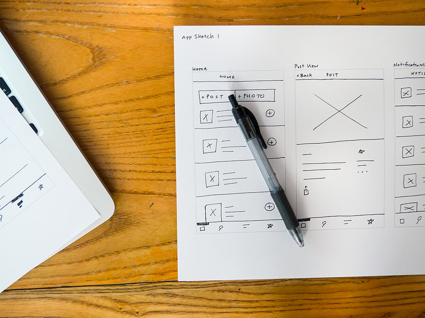 Hand-drawn app wireframe sketch on paper with pen
