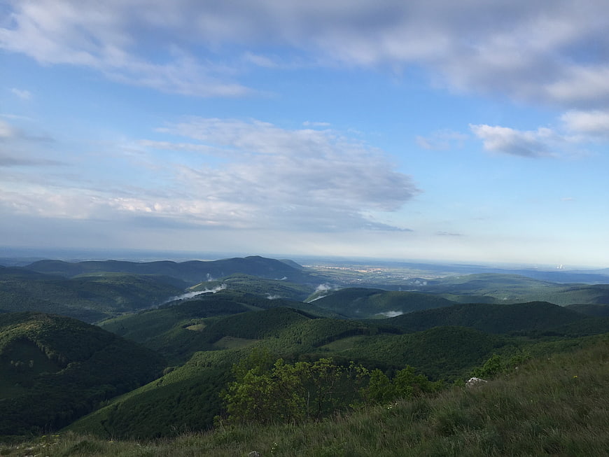 Panoramic View of Rolling Green Mountains and Blue Sky