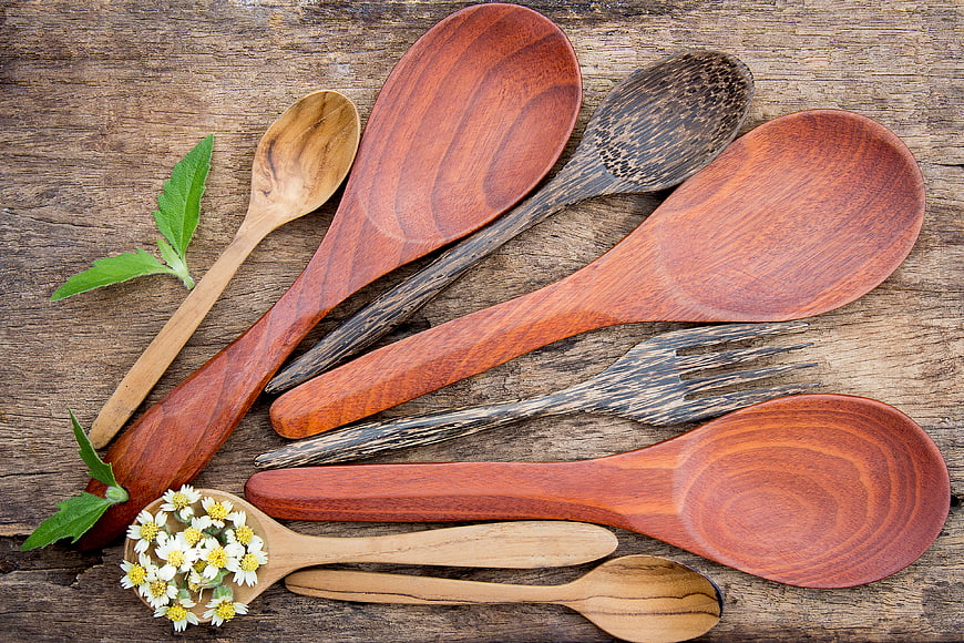 Assorted Wooden Spoons and Forks on Rustic Table