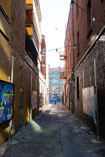 Urban alleyway with brick buildings and string lights