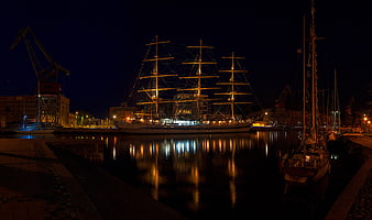 Illuminated Tall Ship Moored in Harbor at Night