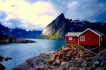 Red Norwegian Cabin by Fjord with Dramatic Mountains