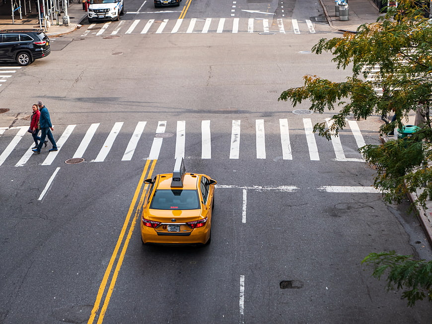 High Angle View of Yellow Taxi at City Intersection