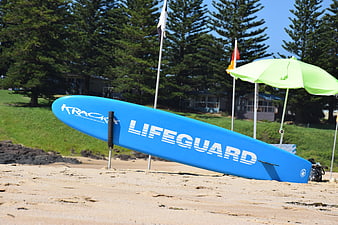 Blue Lifeguard Surfboard on Sandy Beach