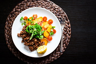 Top view of paleo ground beef with roasted vegetables on white plate