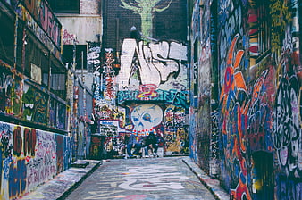 Urban alleyway with colorful graffiti art and mural