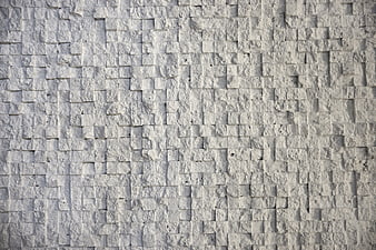 White textured stone wall background with square tiles