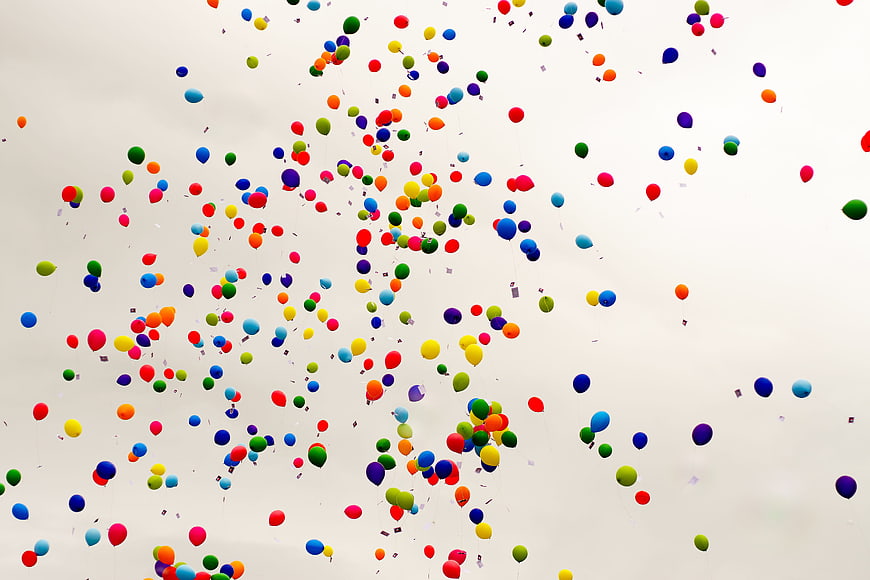 Colorful Balloons Floating in Overcast Sky