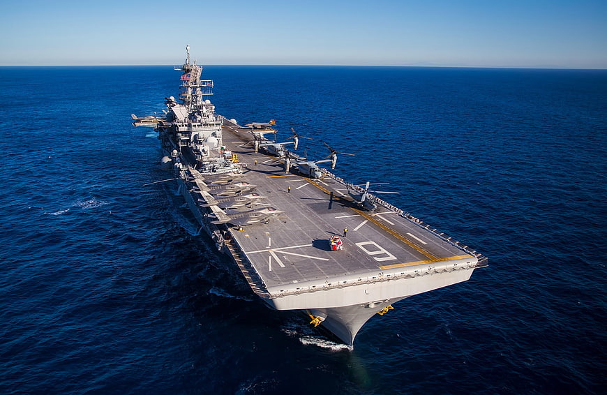 Aerial View of USS America Aircraft Carrier Cruising Deep Blue Ocean