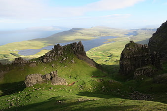 Dramatic Green Highland Landscape with Rocky Outcrops and Loch