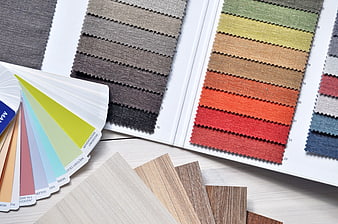 Interior design material samples and color swatches on table