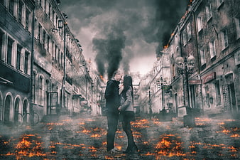 Couple embracing in a burning, destroyed city street