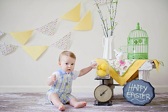 Baby Boy Sitting Near Easter Decorations and Lemons