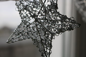 Close-up of silver wire star decoration with intricate details