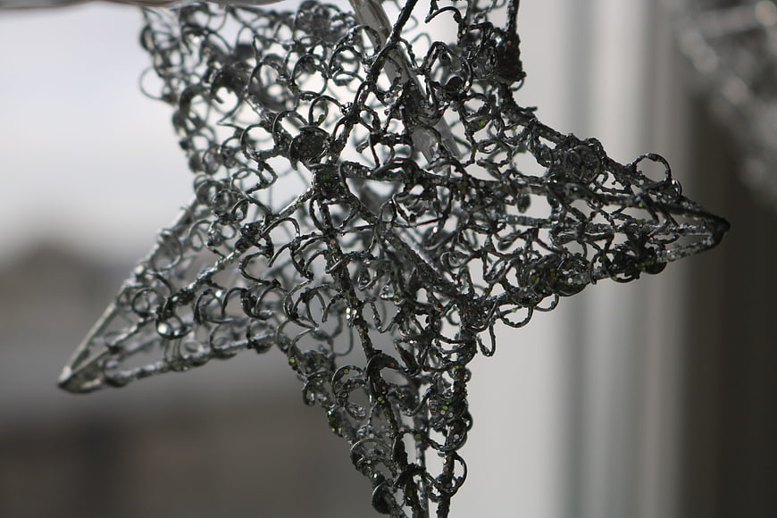 Close-up of silver wire star decoration with intricate details