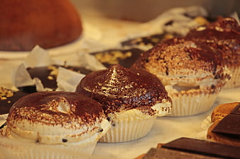 Close-up of chocolate and cream pastries in a bakery display