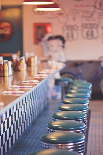 Retro Diner Interior With Teal Bar Stools And Checkered Counter