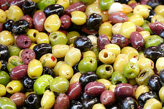Close-up of colorful mixed olives at a market stall