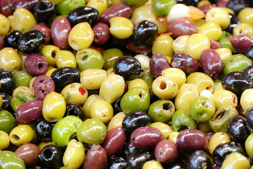 Close-up of colorful mixed olives at a market stall